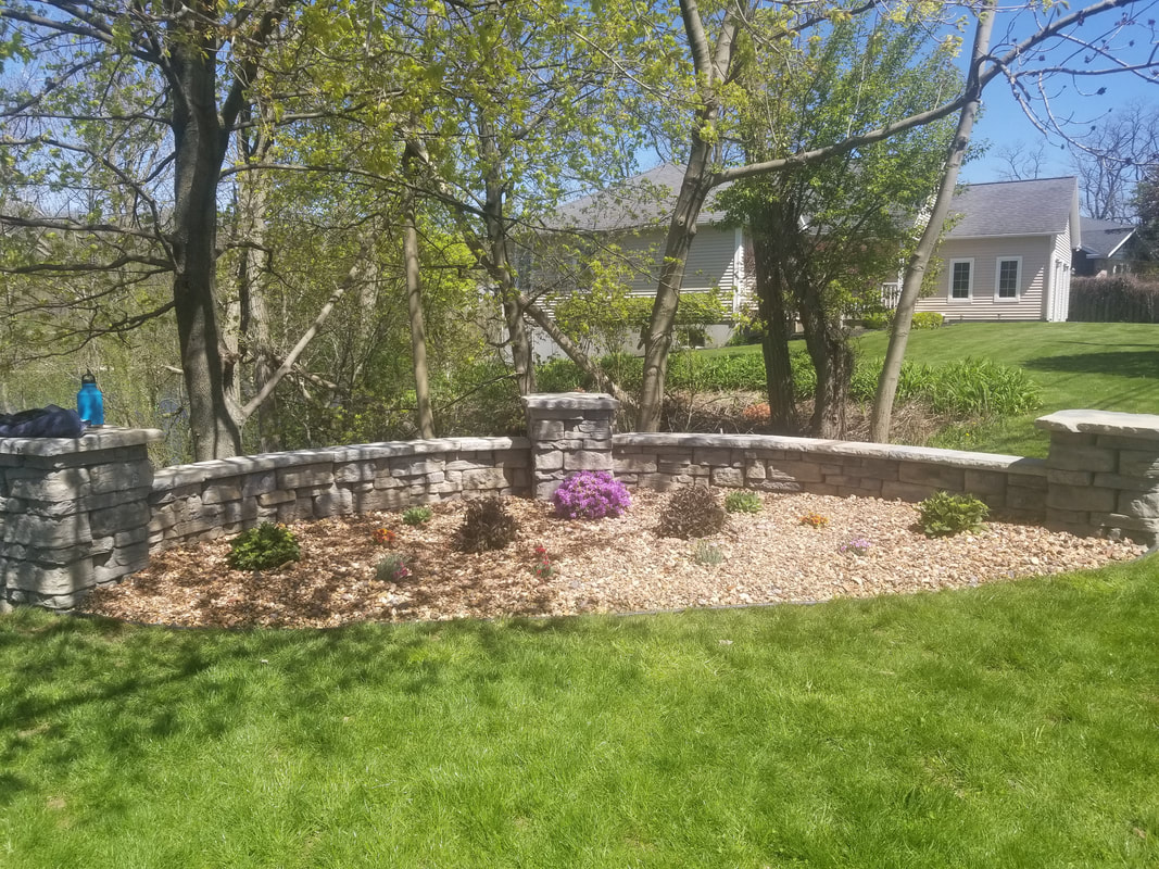 Stone retaining wall and garden in Oswego, NY