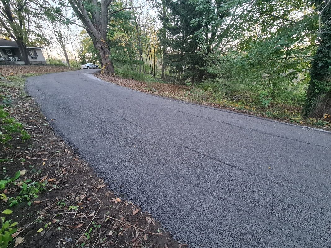 Fresh asphalt driveway paving in Oswego, NY
