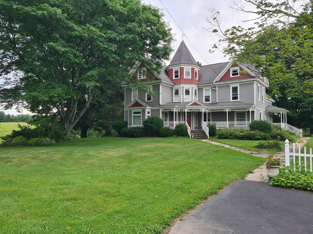 Lawn care and property maintenance at Victorian home in Oswego County